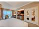 Spacious living area featuring a kitchenette, mirrored closet and an adjacent bed at 135 E Harmon Ave # 3215, Las Vegas, NV 89109
