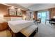 Elegant bedroom features a king bed, sitting area, desk, and floor-to-ceiling windows at 135 E Harmon Ave # 3215, Las Vegas, NV 89109