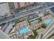 Aerial capture of a rooftop pool area featuring multiple pools, lounge chairs, and city views at 135 E Harmon Ave # 3215, Las Vegas, NV 89109