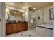 Bright bathroom with a soaking tub and glass-enclosed shower at 145 E Harmon Ave # 3103, Las Vegas, NV 89109