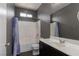 Bathroom with tiled shower and tub, dark cabinets, and grey painted walls at 1766 Molly Meadows St, Las Vegas, NV 89115
