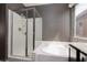 Bright bathroom featuring a glass-enclosed shower and a soaking tub at 1766 Molly Meadows St, Las Vegas, NV 89115