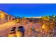 Lush backyard landscaping with cacti and mature trees overlooking the desert and city views at 1779 Sebring Hills Dr, Henderson, NV 89052