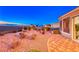 Backyard area has desert landscaping, including rocks, plants, and a view of the city at 1779 Sebring Hills Dr, Henderson, NV 89052