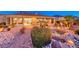 Landscaped backyard featuring a custom water feature, patio and desert landscaping at 1779 Sebring Hills Dr, Henderson, NV 89052