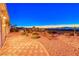 Landscaped backyard featuring desert landscaping, a textured patio, and amazing views of the city lights at 1779 Sebring Hills Dr, Henderson, NV 89052