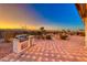 A backyard patio features a built-in gas grill with beautiful views of the desert landscape at 1779 Sebring Hills Dr, Henderson, NV 89052