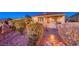 Exterior backyard area has lush landscaping, bushes, and exterior lighting at 1779 Sebring Hills Dr, Henderson, NV 89052