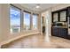 Bright breakfast nook features tile flooring, black cabinets, and views of the desert landscape at 1779 Sebring Hills Dr, Henderson, NV 89052