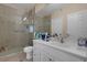 Bright bathroom featuring a glass shower, white cabinets, and neutral toned walls at 1830 N Buffalo Dr # 2043, Las Vegas, NV 89128
