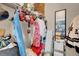 Organized closet space featuring clothing, accessories, and a full-length mirror at 1830 N Buffalo Dr # 2043, Las Vegas, NV 89128