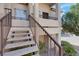 Close up of entry to a unit with a concrete staircase and iron railing at 1830 N Buffalo Dr # 2043, Las Vegas, NV 89128