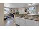Open-concept living area with kitchen, living room, and dining space with a cozy fireplace at 1830 N Buffalo Dr # 2043, Las Vegas, NV 89128