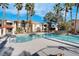 Resort-style pool surrounded by palm trees and well-maintained landscaping at 1830 N Buffalo Dr # 2043, Las Vegas, NV 89128