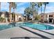 Sparkling community pool surrounded by palm trees and well-maintained landscaping at 1830 N Buffalo Dr # 2043, Las Vegas, NV 89128
