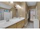 Bright bathroom with a double sink vanity, large mirror, and neutral decor at 206 Red Cloud Ter, Henderson, NV 89015