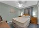 A bedroom with a ceiling fan, carpeted floor, and natural light at 206 Red Cloud Ter, Henderson, NV 89015