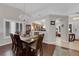 Elegant dining area open to kitchen with hardwood floors and a decorative chandelier at 206 Red Cloud Ter, Henderson, NV 89015