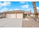 Charming single-story home featuring a three-car garage, desert landscaping, and American flag at 206 Red Cloud Ter, Henderson, NV 89015