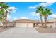 Charming single-story home featuring a three-car garage, desert landscaping, and mature palm trees at 206 Red Cloud Ter, Henderson, NV 89015