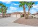 Charming single-story home featuring a three-car garage, desert landscaping, and mature palm trees at 206 Red Cloud Ter, Henderson, NV 89015