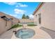 Private backyard with cozy hot tub and artificial turf at 206 Red Cloud Ter, Henderson, NV 89015