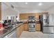 Bright kitchen featuring stainless steel appliances and stone countertops at 206 Red Cloud Ter, Henderson, NV 89015