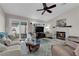 Cozy living room with a fireplace, ceiling fan, sliding glass doors, and comfortable seating at 206 Red Cloud Ter, Henderson, NV 89015