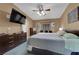 Comfortable primary bedroom features a ceiling fan, a TV, a large window seat and plush carpet at 206 Red Cloud Ter, Henderson, NV 89015