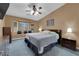 Comfortable primary bedroom features a ceiling fan, a large window seat and plush carpet at 206 Red Cloud Ter, Henderson, NV 89015
