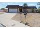Single-story home featuring desert landscaping, a two-car garage, and a unique roof at 230 Queen Marie Ct, Henderson, NV 89015