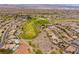 Picturesque aerial view of a community next to a beautiful golf course with vibrant green fairways and landscaping at 2585 Shellsburg Ave, Henderson, NV 89052