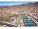 A beautiful aerial view of homes, community center with tennis courts, bocce ball, and pool for an active lifestyle at 2585 Shellsburg Ave, Henderson, NV 89052