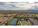 Extensive aerial view featuring community tennis courts, landscaping, and desert mountain backdrop at 2585 Shellsburg Ave, Henderson, NV 89052