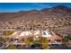Community building featuring ample parking, solar panels, and lush trees, with a mountain backdrop for a great quality of life at 2585 Shellsburg Ave, Henderson, NV 89052