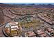 Panoramic aerial showcases the community, tennis courts, pools and homes against a backdrop of mountains on the horizon at 2585 Shellsburg Ave, Henderson, NV 89052