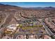 Extensive aerial view of a residential area with multiple tennis courts in the center of a beautifully designed community at 2585 Shellsburg Ave, Henderson, NV 89052