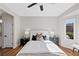 Bright bedroom with ceiling fan, modern lamps and nightstands, and a view to a window at 2585 Shellsburg Ave, Henderson, NV 89052