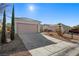 Charming single-story home featuring a two-car garage, desert landscaping, and a well-maintained front yard at 2585 Shellsburg Ave, Henderson, NV 89052