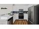 Well-equipped kitchen featuring white cabinets, stainless steel appliances, and stylish countertops at 2585 Shellsburg Ave, Henderson, NV 89052