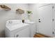 Laundry room with modern washer, dryer, and shelving for storage at 2585 Shellsburg Ave, Henderson, NV 89052