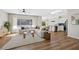 Open-concept living room showcasing hardwood floors, modern furniture, and a seamless flow to the kitchen at 2585 Shellsburg Ave, Henderson, NV 89052
