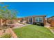Landscaped backyard featuring patio with seating area and artificial turf, perfect for outdoor enjoyment at 2767 Flowing Breeze St, Henderson, NV 89044