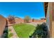 Manicured backyard with artificial turf, brick border and planting beds for a lush, green space at 2767 Flowing Breeze St, Henderson, NV 89044