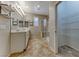 Bathroom featuring double sink vanity, a glass shower, and a walk-in closet with wire shelving for optimal organization at 2767 Flowing Breeze St, Henderson, NV 89044