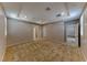 Expansive carpeted bedroom featuring tray ceiling, neutral walls, multiple doorways, and great natural light from a window at 2767 Flowing Breeze St, Henderson, NV 89044