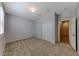 A carpeted bedroom features a closet, whitewashed accent wall, and shutters on the window at 2767 Flowing Breeze St, Henderson, NV 89044
