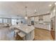 Bright, open kitchen with white cabinets, stainless steel appliances, and a large center island with seating at 2767 Flowing Breeze St, Henderson, NV 89044