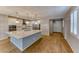 Bright kitchen features a large island, stainless appliances, and stylish pendant lighting at 2767 Flowing Breeze St, Henderson, NV 89044