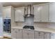 Close-up of the kitchen featuring a modern gas cooktop and stainless steel range hood at 2767 Flowing Breeze St, Henderson, NV 89044